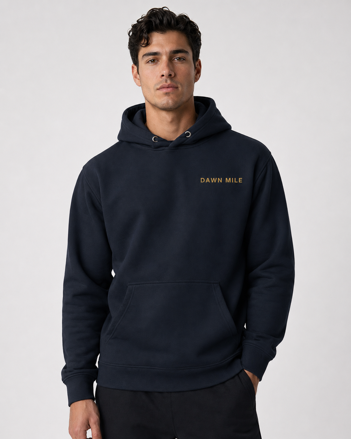 Man wearing a navy hoodie with 'Dawn Mile' logo on a light gray background